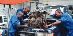 Mechanics working on a car engine at Stantech motors garage