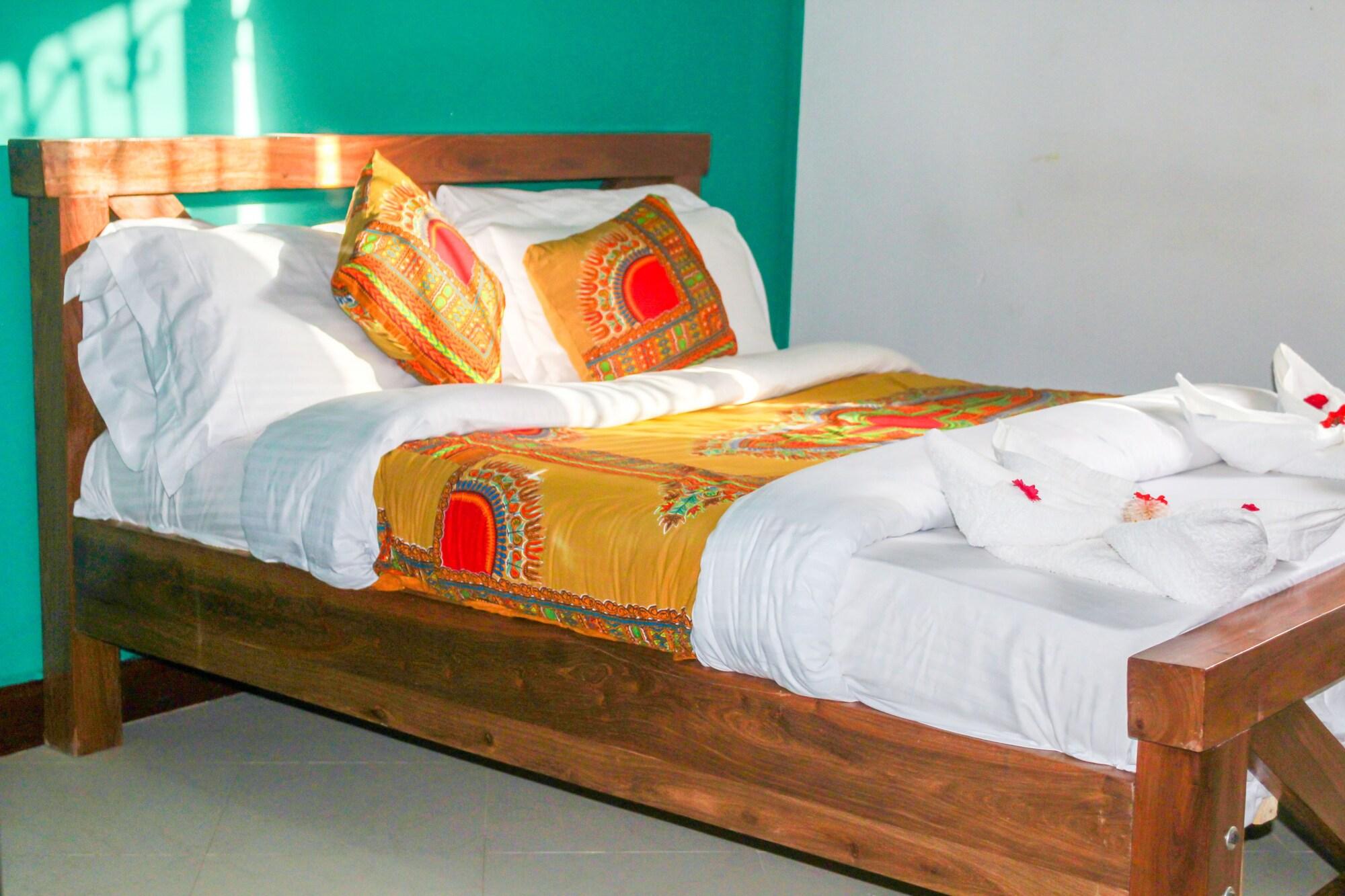 A bed at Sinzia Villas in Arusha