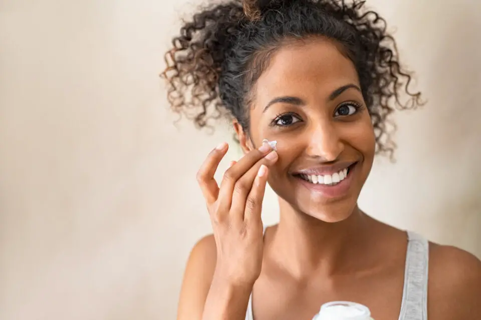 Advantages of Shea Butter on the Skin: a black woman applying shea butter on her face